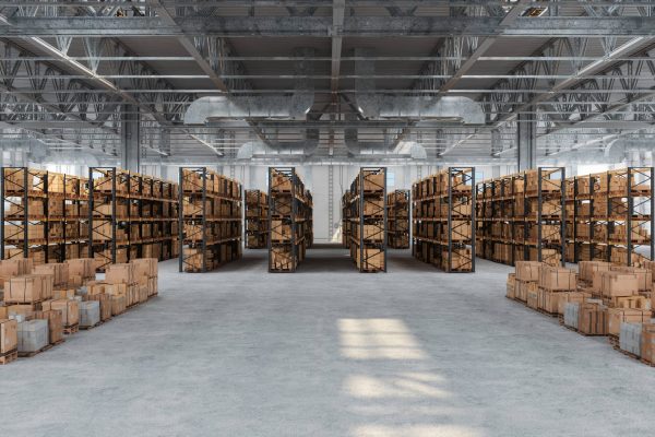 Distribution-Warehouse-With-Cardboard-Boxes-On-The-Racks-And-On-The-Floor-1440668597_7050x4700-min